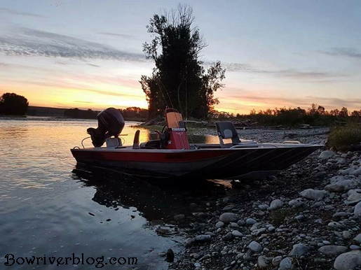 Explorer industries jet boat rests on the bank of the bow river Alberta